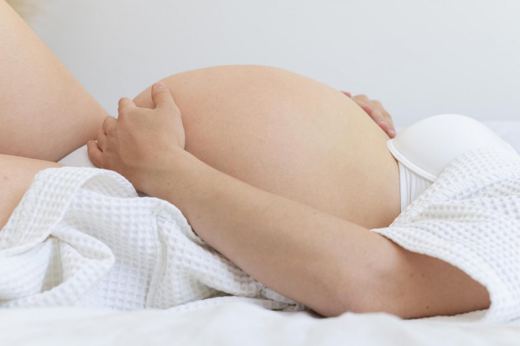 femme enceinte allongée sur son lit